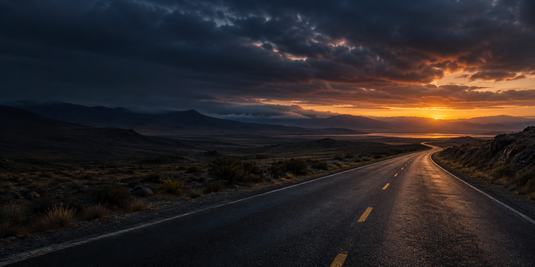 Een verlaten weg onder een donkere lucht, richting licht aan de horizon